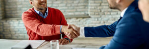 two gentlemen shake hands after hiring top talent through passive sourcing